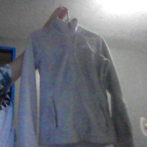 a grey zip up jacket.